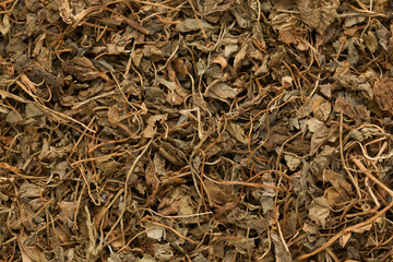 Organic Kasoori Methi or Dried fenugreek (Trigonella Foenum Graecum) leaves. Macro close up background texture. Top view.