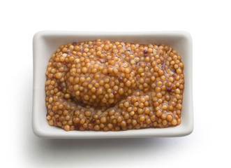 Grainy mustard in the white plate
