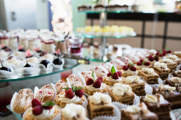 Luxury cakes on wedding dessert table in restaurant