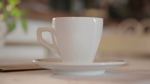 A man puts a cup of coffee on the table