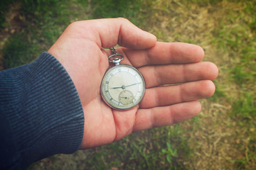 Old pocket watch in a man's hand