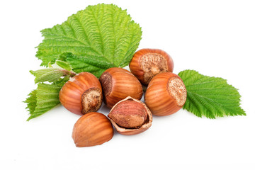Hazelnut or filbert nuts with leaves on white background