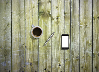 Office desk top view mock up image with smartphone, pen and coffee. Wooden background