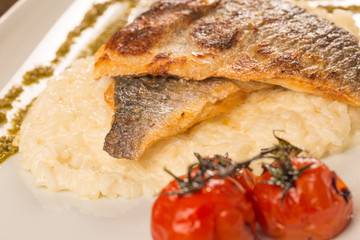 Grilled trout with risotto, tomatoes, and pesto