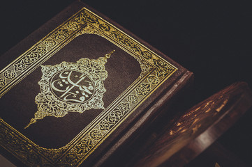 Fototapeta na wymiar Closeup The Quran literally meaning 'the recitation' religious provision of Islam. Vintage style picture