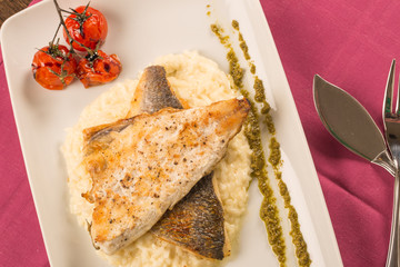 Grilled trout with risotto, tomatoes, and pesto