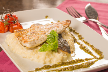 Grilled trout with risotto, tomatoes, and pesto