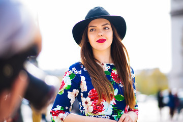 emotional portrait fashion stylish portrait of pretty young brunette woman hipster, go crazy, elegant black hat, soft colors, crazy cold girl.Red city wall background.surprised girl close-up