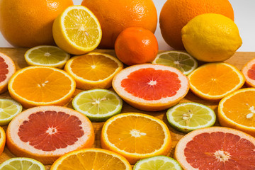 Citrus fruit background with sliced f oranges lemons lime tanger
