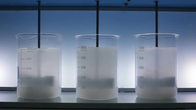 Mixing liquid with laboratory stirrer. Laboratory mixer.