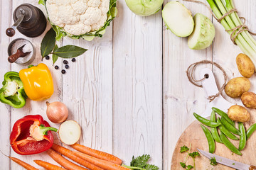 Delicious fresh veggies forming a frame on wood