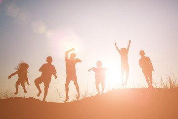 Silhouette Children playing on summer sunset happy time