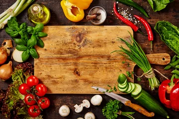  Cutting Board and Knife with Vegetables on Table © exclusive-design
