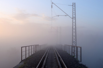 Sunrise and morning mist over the railway