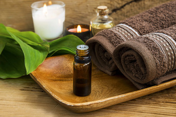 Spa treatment with oil, candles and cotton towels