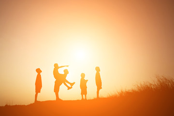 Silhouette Children playing on summer sunset happy time