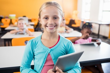 A cute pupil posing with tablet pc