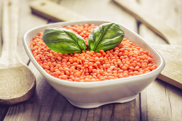 Orange lentils in white bowl
