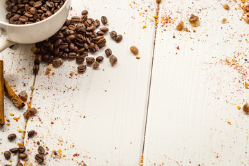 Coffee Beans, Cinnamon and Brown on Light White Wooden Table, free Space for Text