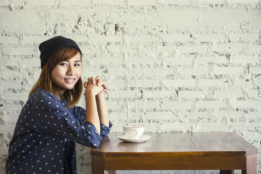 Beautiful woman sitting with coffee cup in a cafe