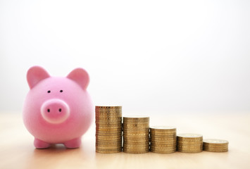 Pink piggy bank and coins 