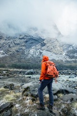 Hiker at foothill observes his goal
