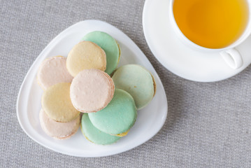  French colorful macaroons sweet dessert and with a cup of tea.