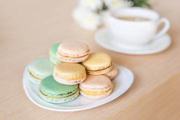  French colorful macaroons sweet dessert and with a cup of tea.