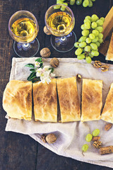 Сheese pie, strudel with cheese, cheese pie 4. Wine, grapes, nuts, cheese, blue cheese, and coffee. dinner, lunch, romantic date, picnic, eating on nature.