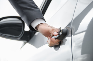  Close-up of businessman  opening a car door.
