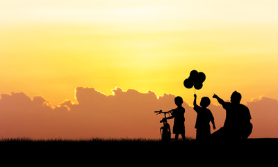 Fototapeta na wymiar Silhouette of father and boy standing sunset background
