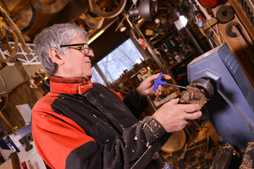 Wood turners using a rotating clamp to turn the wood.
