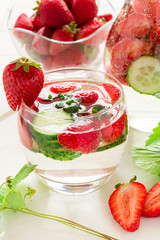Detox. Fresh lemonade with strawberries, cucumber and mint on white wooden table