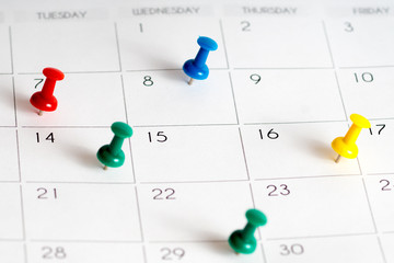 colorful pins on calendar grid