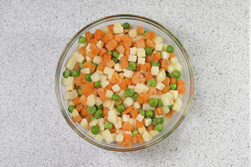 Peas, potatoes and carrots in a bowl