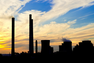 Fototapeta na wymiar a silhouette of power plant at dusk