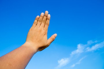 hand in blue sky