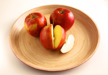 Fototapeta na wymiar Red apples on a wooden plate on the table
