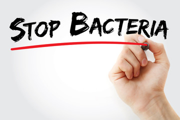Hand writing Stop Bacteria with marker, health concept background