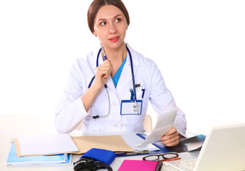 Happy smiling young beautiful female doctor showing blank area for sign or copyspace, isolated over white background