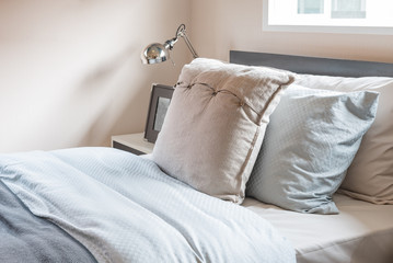 single bed with pillows in modern bedroom