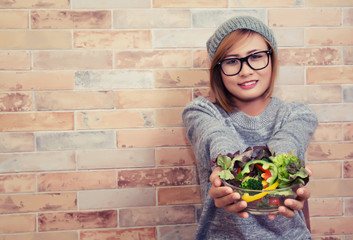 Hipster woman wearing glasses sitting on the chair with her sala