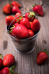 strawberries in tiny metal bucket