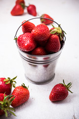 strawberries in tiny metal bucket