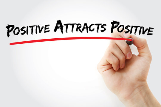 Hand writing Positive Attracts Positive with marker, health concept background