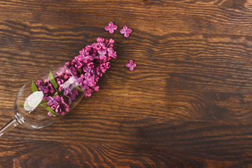 Wineglass with violet lilacs