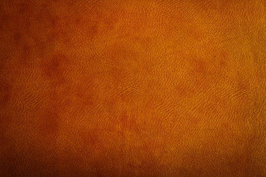 Brown leather texture closeup can be used as background.