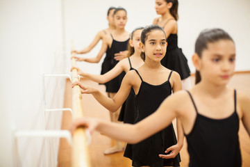 Girls wearing a leotard taking dance class