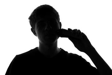 young man shaving with electric razor