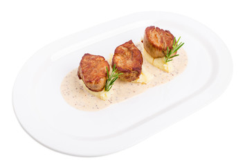 Fried pork tenderloin medallions on mashed potatoes.